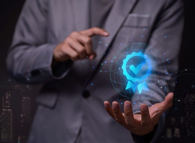 A hologram of a 3D rendering of a verification sign as top service Quality assurance, standardization, and Standards Guarantee and a man explaining it